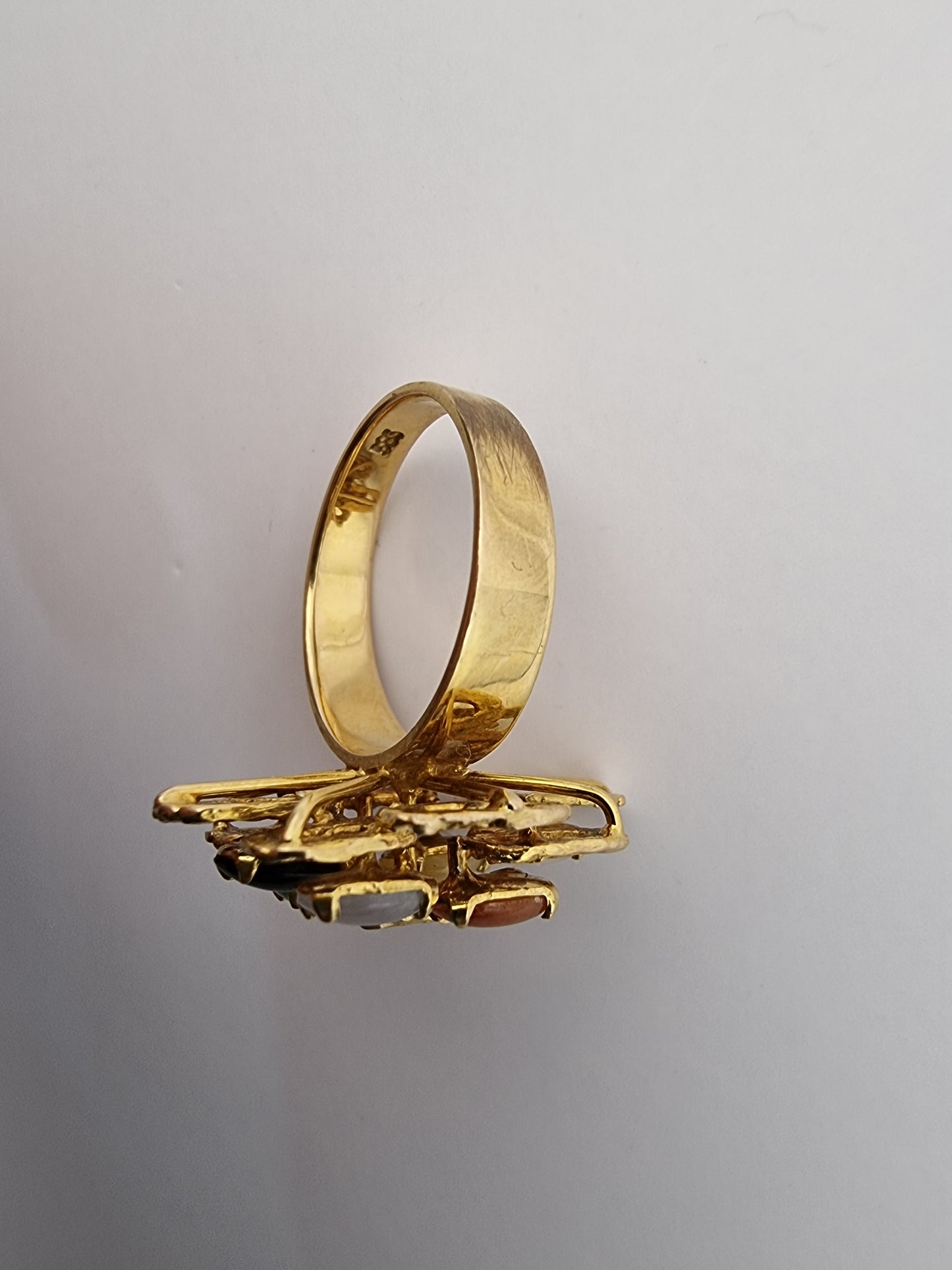 This stylish ring is made of 14ct yellow gold contains 6 multi coloured jade stone